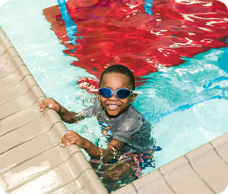 A student and instructor practicing professional swim techniques in the Spring, TX, indoor facility.